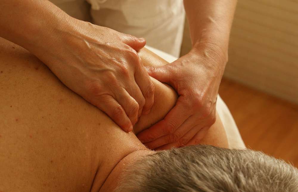 Male client taking deep tissue therapy in Faisalabad